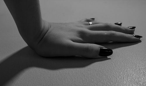 Close-up of woman hand on wall