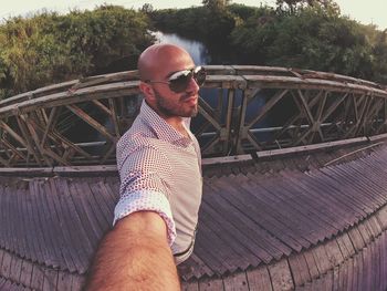 Fish eye view of man standing on footbridge