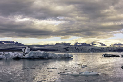 Scenic view of frozen lake against sky during winter