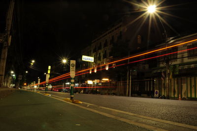 Illuminated road in city at night