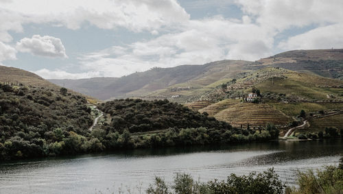 Scenic view of lake and mountains against sky