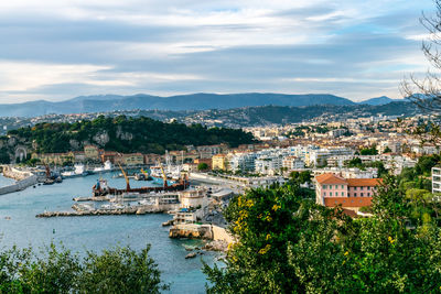 High angle view of townscape by river against sky