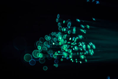 Close-up of illuminated lights over black background