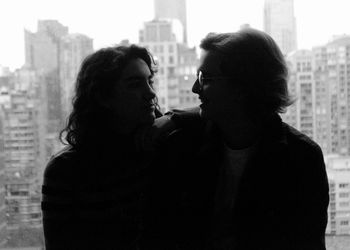 Rear view of couple standing in city