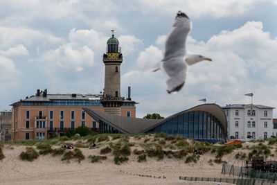 Low angle view of lighthouse against cloudy sky