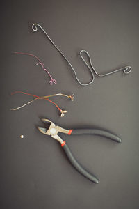 Pliers and wire flowers on table