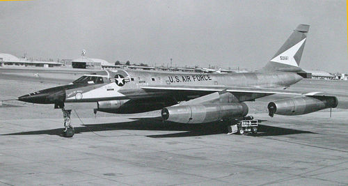 Airplane on airport runway against sky