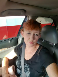 Portrait of woman sitting in car