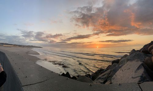 Scenic view of beach against sky during sunset