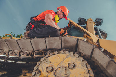 Low angle view of man standing on slide