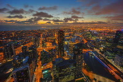 High angle view of city lit up at night