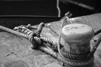 Close-up of rope tied up on rusty metal