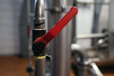 Close-up of  pipe with red valve
