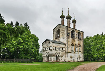 View of trees and building against sky