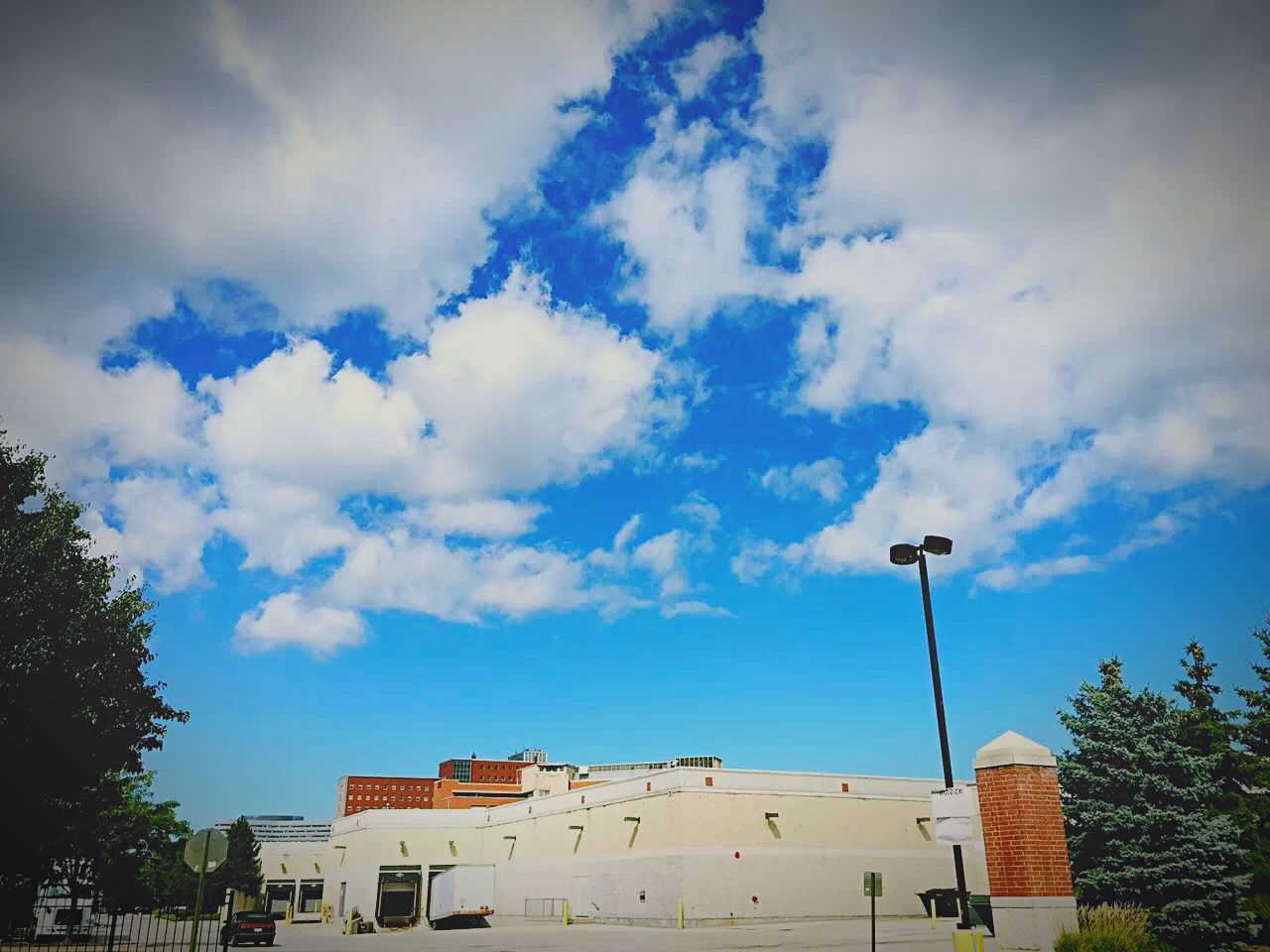 building exterior, architecture, built structure, sky, low angle view, street light, cloud - sky, house, tree, cloud, residential structure, residential building, blue, cloudy, building, day, outdoors, high section, no people, roof