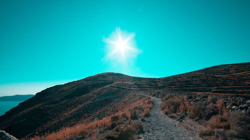 Scenic view of mountains against clear blue sky