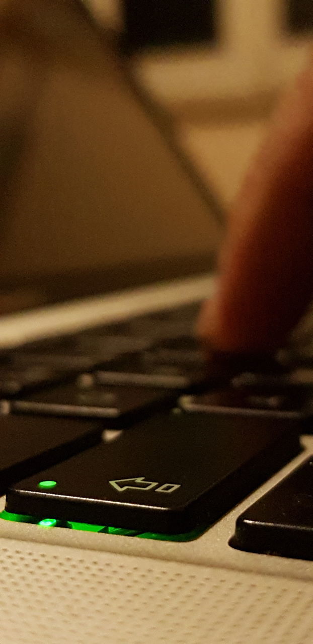 CLOSE-UP OF LAPTOP ON TABLE AT HOME