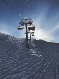 Low angle view of ski lift against sky