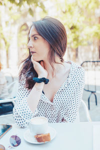 Woman looking away while coffee