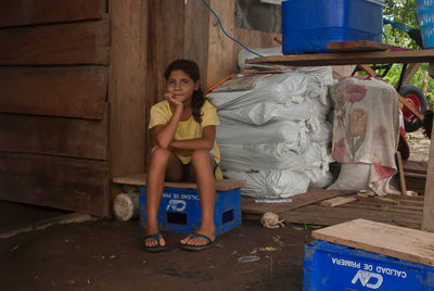 Portrait of smiling girl sitting outdoors