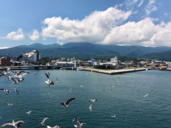 Scenic view of sea by city against sky