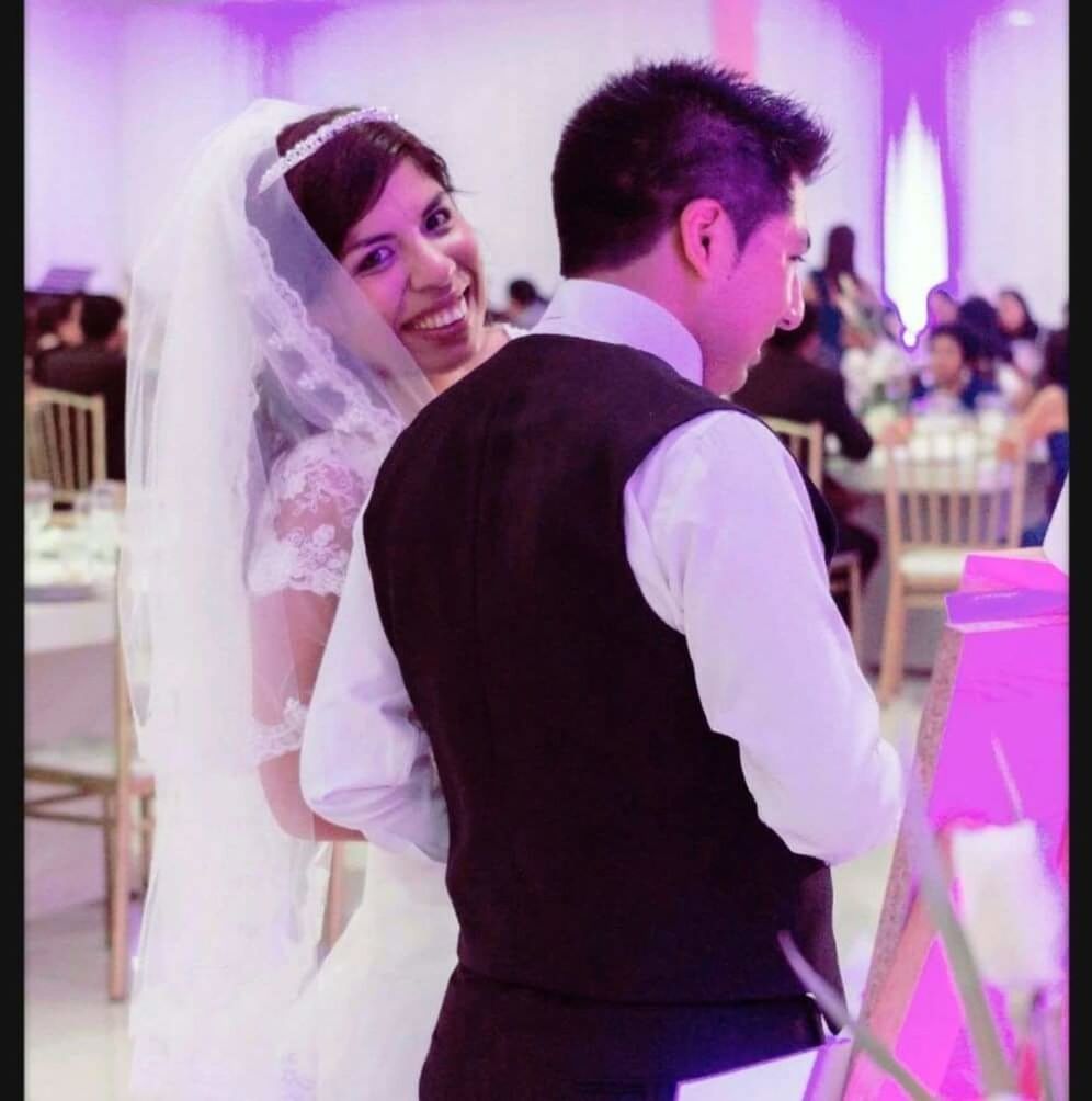 PORTRAIT OF A SMILING YOUNG COUPLE KISSING