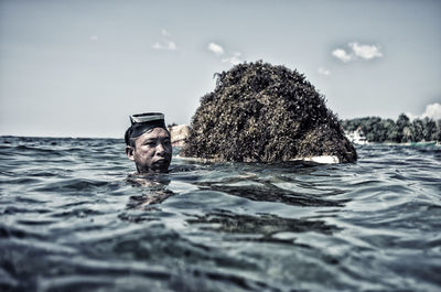 Portrait of man swimming in sea