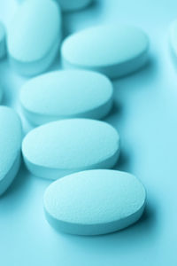 Close-up of medicines over turquoise background