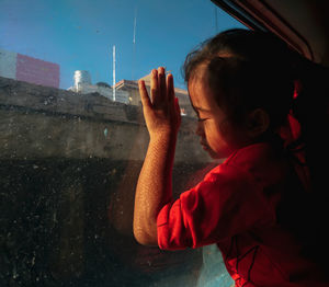 Midsection of woman holding window