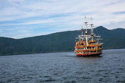 Nautical vessel on sea against mountains