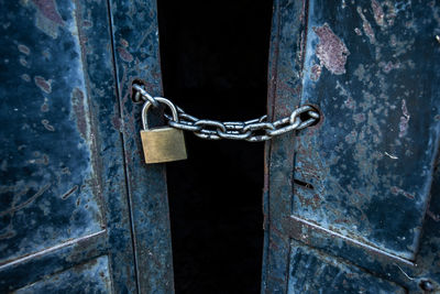 Close-up of padlock on metal door