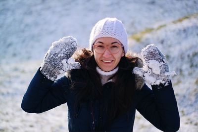 Portrait happy woman enjoying snow
