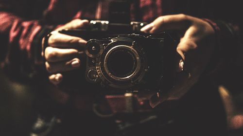 Close-up portrait of man holding camera