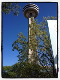 Low angle view of tower against blue sky