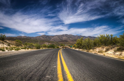 Empty road with mountains in background