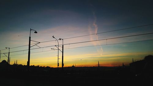 Low angle view of silhouette birds flying against sky during sunset