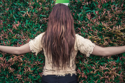 Woman standing in front of plants