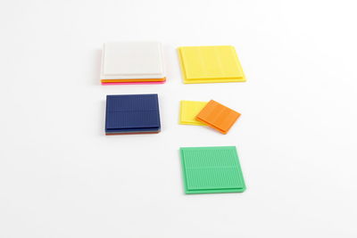 High angle view of colored pencils on white background