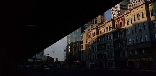 Low angle view of buildings against clear sky at night