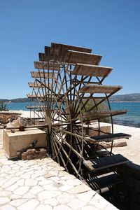 Built structure on beach against clear blue sky