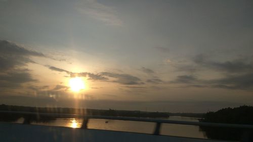 Scenic view of river against sky during sunset