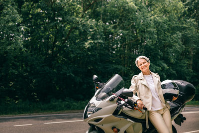 Portrait of man riding motorcycle on road