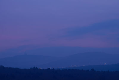 Scenic view of silhouette landscape against sky at night