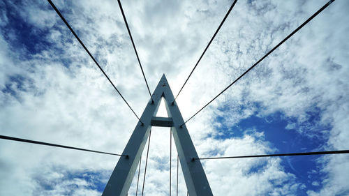 Low angle view of bridge against cloudy sky