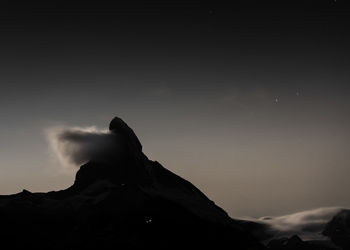 Low angle view of silhouette rock against sky at sunset