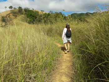 Full length of woman walking on field