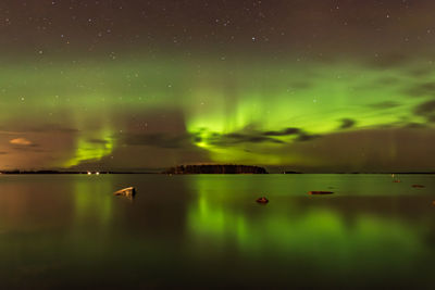 Scenic view of lake against sky at night