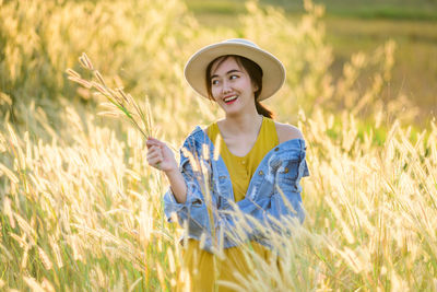 Portrait of teenage girl standing in field