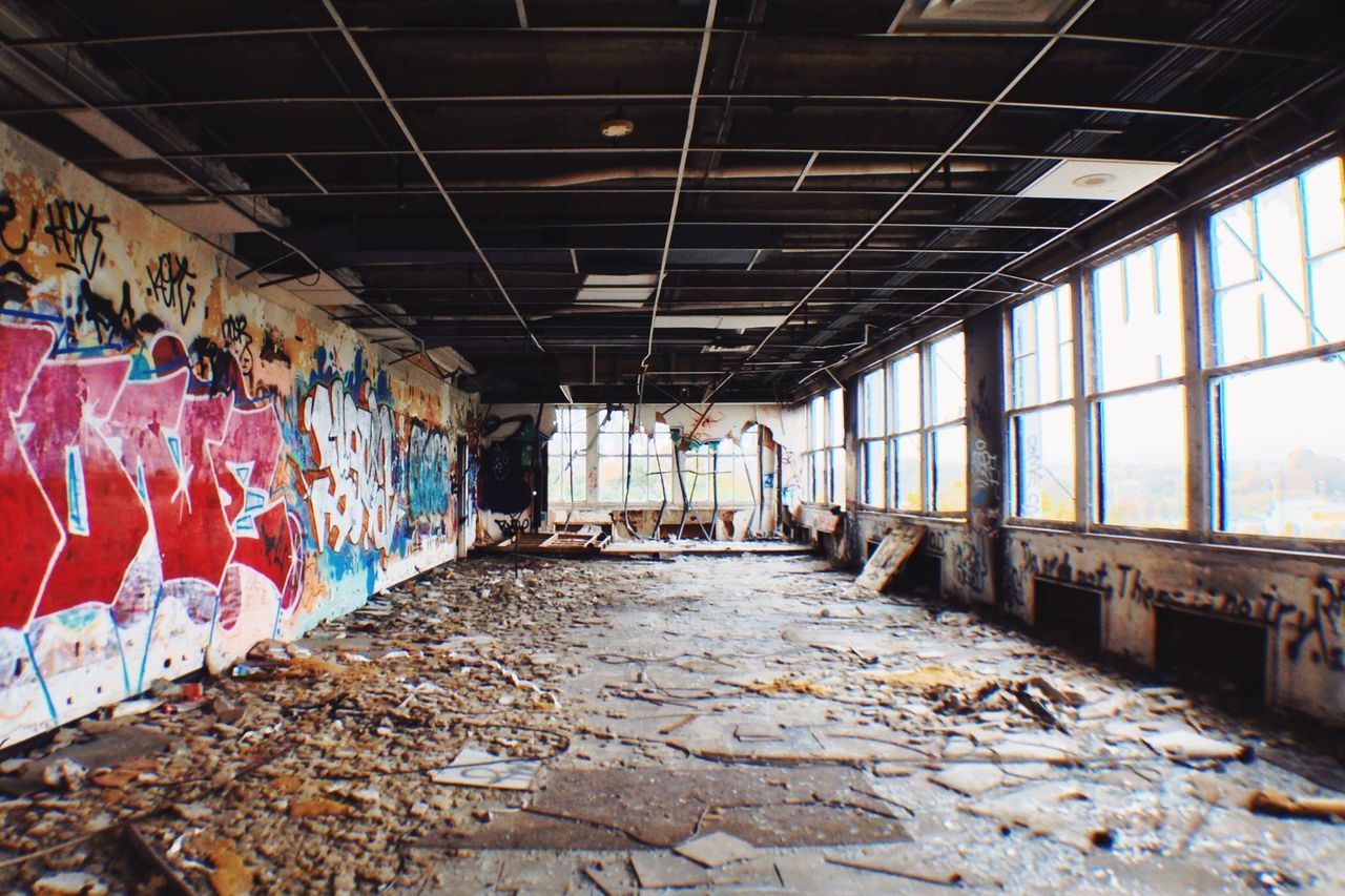 graffiti, architecture, built structure, indoors, ceiling, the way forward, wall - building feature, diminishing perspective, abandoned, messy, empty, interior, art, building, vanishing point, deterioration, wall, art and craft, day, damaged