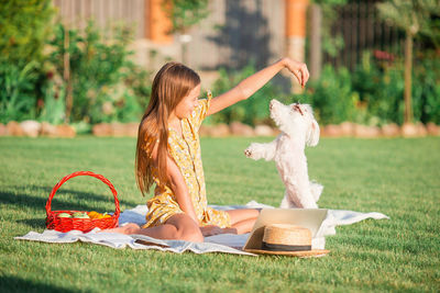 Midsection of woman reading book on field